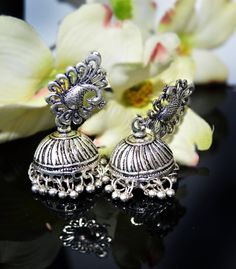 These are beautiful artisan handmade Jhumkas. The celebrity is wearing a similar styled piece but not the same. These are Beautiful jhumkas and are not heavy as they might seem.  ** Bollywood actress picture courtesy Google. These are a statement style piece. Wear them on your little black dress or ethnic clothes and rock it . Thank you for your support Go back to Storefront Taneesijewelry.etsy.com  View my Entire STERLING SILVER EARRINGS Collection at https://www.etsy.com/shop/taneesijewelry?se Navratri Peacock Design Jhumkas, Gift Peacock Design Jhumkas, Chandbali Danglers With Peacock Design, Bollywood Silver Jhumkas With Peacock Design, Silver Peacock Design Jhumkas For Navratri, Silver Jhumkas With Peacock Design, Festive Silver Jhumkas With Peacock Design, Silver Jhumka Earrings, Dome Chandelier