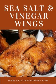 two pieces of chicken on a plate with dipping sauce and text overlay saying sea salt and vinegar wings