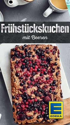 a square cake with blueberries and cranberries on it