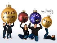 three people holding up christmas ornaments in front of their faces, with the words merry new year and 2009 written on them