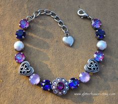 Brand new to my shop... romantic floral Swarovski crystal statement bracelets! This bracelet is equal parts timeless elegance and modern romance. Perfect to give as a gift to someone special or keep as a sweet treat just for you.  This bracelet features 11 genuine Swarovski crystals and two Swarovski pearls, all in various shades of purple. This color combination is fiercely feminine and bold. Each crystal has been hand set into a four prong antique silver plated setting. This style bracelet would look stunning for bridesmaids and bridal parties! It can be made featuring many different crystal colors and color combinations. The possibilities are endless! This bracelet is adjustable from 6.5 to 8.5 inches and is finished with a lobster style clasp. You can find many more handmade Swarovski Fiercely Feminine, Statement Bracelets, Sparkly Ring, Swarovski Crystal Jewelry, Modern Romance, Wedding Jewelry Bracelets, Bridesmaid Bracelet, Romantic Valentine, Statement Bracelet