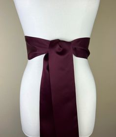 "Wide Maroon Sash in Matte Satin  Maroon Sash Belt  Dark Burgundy Sash Belt  Matte Satin Sash, Dress Sash  Maroon Waist Sash  This Satin Swank® wide waist sash is the perfect finishing touch for your special occasion dress or just the right piece to add instant polish to your outfit. Depending on your waist size and the length you choose, you can wrap the sash around your waist once or twice. You decide whether to tie the sash in a bow or a simple knot with long-hanging tails. Tie in front, in back, or on the side. A double layer of matte satin fabric in maroon, this sash is the same front and back with ends finished on the angle and seams hidden within the fold lines.   SIZING/COLOR/PRINT INFO: The mannequin pictured is wearing the 75 inch sash length and has a 28 inch waist. Sizes availa Elegant Belted Sashes For Formal Occasions, Elegant Formal Belted Sashes, Formal Fitted Sash With Tie Waist, Formal Sashes With Matching Belt, Elegant Fitted Tie Waist Sash, Formal Fitted Belted Sashes, Elegant Fitted Sashes With Matching Belt, Elegant Formal Sash With Satin Finish, Burgundy Sash Belt