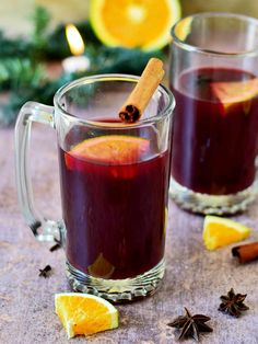 two mugs filled with mulled and orange slices