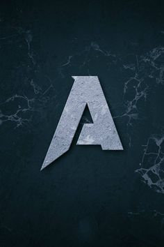 the letter a made out of concrete on a black background with some cracks in it