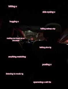 the inside of a car at night with words written in pink and white on it