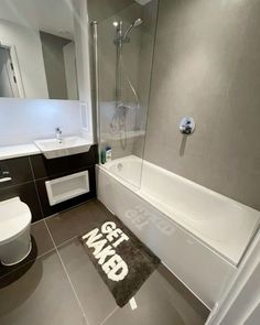 a bathroom with a bathtub, toilet and sink in it's center area