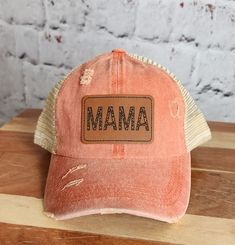 Being a mom doesn't mean you have to sacrifice your sense of style. Embrace the chic and trendy side of motherhood with our Trendy Mama Hat! This hat is designed exclusively for mamas who want to stay fashionable while juggling their busy lives. Crafted with both fashion and functionality in mind, our Women's Ponytail Hat features a cleverly designed opening at the back, allowing you to comfortably wear your ponytail or bun without compromising on style. Say goodbye to awkwardly squeezing your h Retro Distressed Adjustable Hats, Distressed Brown Summer Hat, Retro Adjustable Distressed Hats, Adjustable Distressed Pink Hat, Trendy Distressed Adjustable Hat, Trendy Adjustable Distressed Hat, Spring Adjustable Distressed Hats, Spring Distressed Adjustable Hat, Adjustable Hats With Letter Print