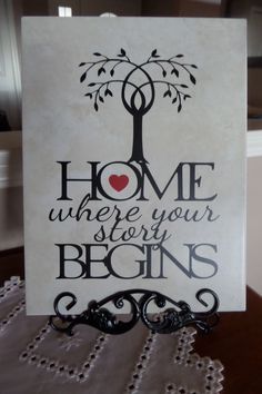 a card with the words home where your story begins on it and a tree in the middle