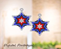 two pixellated stars hanging from strings on a window sill with the words digital portugal written in red, white and blue