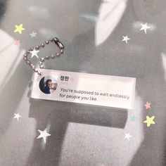 a keychain with a message attached to it sitting on a surface covered in stars