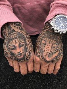 two hands that have tattoos on them