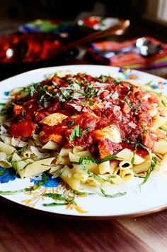 a white plate topped with pasta covered in sauce