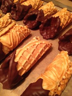 chocolate covered waffles and other pastries on a baking sheet