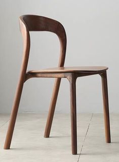 a wooden chair sitting on top of a white floor