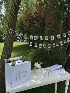 a table that has some pictures on it and a box sitting on top of it