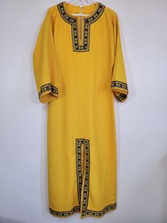 I love this one - can't tell if it's home made or not!  It's a Vintage 1970s Unknown Brand mustard yellow gold metallic rickrack floral trim long caftan/house dress! Measured women's bust 38" Metallic gold rickrack and daffodil-like flowers. Lace inside up the bottom hem. Fabric is textured almost like bark cloth. Superb tailoring! Looks like something Black Moth Super Rainbow would wear (they were wearing white when I saw them).  Or is it religious in nature? Is there a difference?  Please see our other listings for more vintage garments with new items added nearly daily. PLEASE check the measurements as vintage 70s clothing sizes may not comparable to contemporary sizes. Measurements: Label size: none present Shoulder-to-shoulder: 21" Chest across: 19" Sleeve from shoulder: 16" Length in Fitted Long Bohemian Thobe, Yellow Long Sleeve Kaftan For Festival, Bohemian Fitted Long Thobe, Fitted Yellow Bohemian Kurta, Yellow Fitted Bohemian Kurta, Traditional Yellow Long Sleeve Tunic, Fitted Long Yellow Kurta, Fitted Yellow Maxi Kurta, Festival Long Sleeve Yellow Kaftan