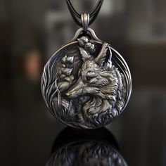 Introducing our Fox Shield themed 925 Sterling Silver Necklace, a unique piece of jewelry that combines the cunning of the fox with the strength of a shield. This handmade necklace is not just an accessory, but a statement piece that reflects the resilience and intelligence of nature. Each necklace features a meticulously designed Fox Shield emblem, a symbol of protection and agility. Made from high-quality 925 sterling silver, it promises durability and a timeless shine that won't tarnish. The Silver Nature-inspired Jewelry, Collectible Carved Round Jewelry, Bronze Carved Jewelry As Gift, Bronze Carved Jewelry For Gifts, Antique Jewelry With Lost Wax Casting Round Pendant, Bronze Carved Jewelry Gift, Collectible Carved Bronze Jewelry, Bronze Carved Collectible Jewelry, Artistic Engraved Bronze Jewelry