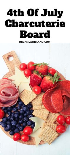 the 4th of july charcuterie board with strawberries, grapes, tomatoes and cheese