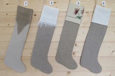 three stockings are hanging on the wall and numbered with numbers for each sock to sew