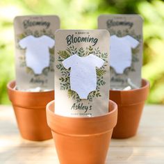 a baby is blooming card sitting in a flower pot