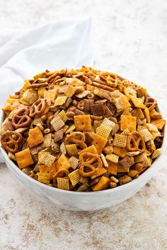 a white bowl filled with cheetos and pretzels