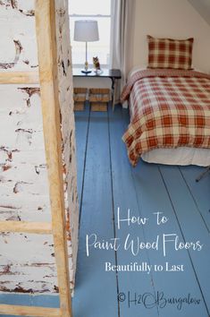 a bed sitting next to a window on top of a blue floor in a bedroom