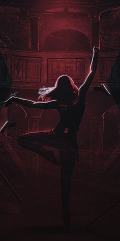 a woman is dancing in the dark with red lighting