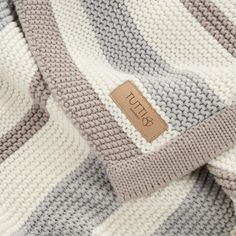 a close up of a sweater with a tag on it