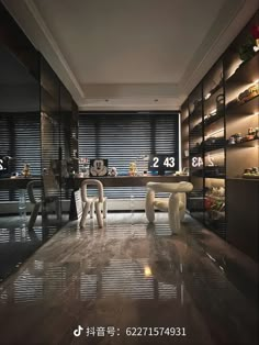 an empty room with two white chairs in front of the wall and shelves full of shoes