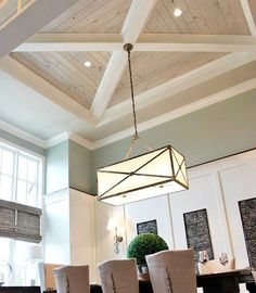 a chandelier hanging from the ceiling in a dining room