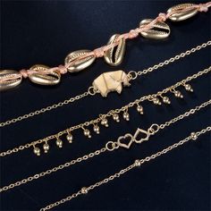 Add a little oomph to your latest pedicure or favorite shoes when you accessorize with this gleaming 18-karat gold-plated anklet set. Wear them stacked together or solo for a boho-chic look. Includes one elephant charm anklet, one shell charm anklet, one double-heart anklet, one bead-accent charm anklet and one bead-accent station anklet (five pieces total) Lobster claw clasp 18k gold-plated copper / vibre Trendy Gold Anklets For Festivals, Trendy Gold Anklet As Gift, Trendy Gold Anklets Perfect For Gifts, Dainty Gold Anklets For Festivals, Bohemian Gold Anklets As A Gift, Bohemian Gold Anklets For Gift, Origami Elephant, Charm Anklet, Heart Anklet