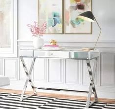 a white desk with a black and white rug