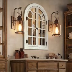 an old fashioned bathroom with wooden cabinets and mirrors