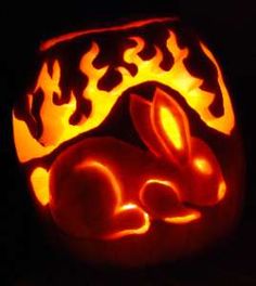 a pumpkin carved to look like a rabbit sleeping