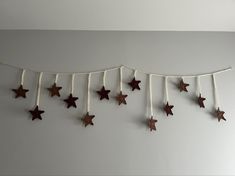 several wooden stars are hanging on a string