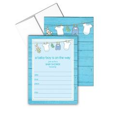 a baby boy is on the way card with clothes hanging from a line and blue wood background