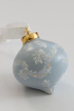 a blue ornament with white flowers on it