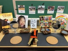 the table is set up with books, pictures and other items for children's arts and crafts