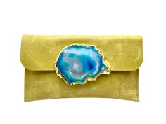 Made using the finest quality Italian leather, this clutch is super stylish and unique. A definite statement piece with a focal sliced blue geode stone accent. It is the perfect size to fit your cell phone, keys and lipgloss for a night out and measures 9 inches in length and 6 inches inches in height. It is fully lined with a metallic gold leather interior. It secures with a magnetic clasp. This is a one of a kind piece Leather Clutch With Magnetic Closure For Gift, Chic Clutch With Magnetic Closure As Gift, Geode Stone, Statement Clutch, Blue Geode, Greenville Sc, Magnetic Clasp, Gold Leather, Leather Purse