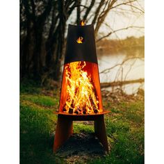 a fire pit sitting on top of a lush green field