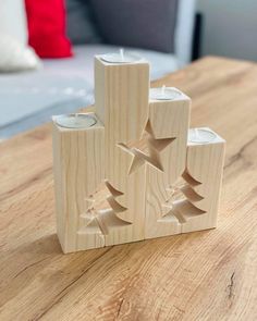 three wooden candles sitting on top of a table next to a couch in a living room