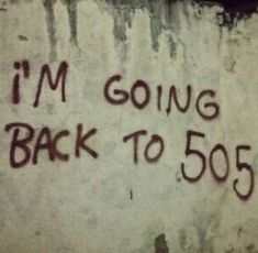 graffiti on the side of a building that says i'm going back to 505