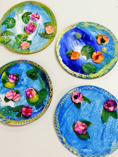 four paper plates with flowers painted on them