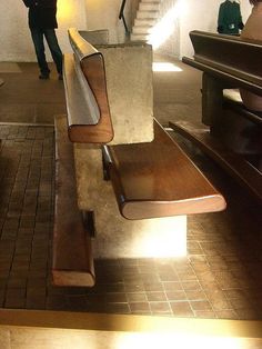 a wooden bench sitting in the middle of a room