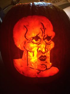 a carved pumpkin with an image of a man's face on it