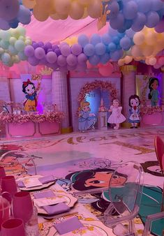 there are many balloons hanging from the ceiling in this pink and blue party room with princesses on it