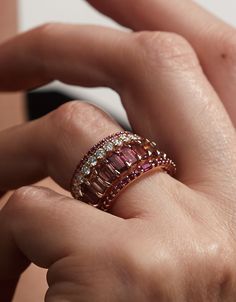 A luminous ring, with rubies. A unique stacking ring, a subtle wedding band, or a wedding band and engagement ring all in one. 14K sustainable gold Center: 0.07ct ruby baguette 0.29 tcw round rubies Dimensions: Band width 1.9mmDelivery: Please allow up to 1-2 weeks for delivery. For rush orders please contact our Concierge. Baguette Ruby Ring, Ruby Ring Stack, Heavy Rings For Women, Fine Jewelry Ruby Ring With Baguette Diamonds For Wedding, Wedding Rings With Ruby And Baguette Diamonds, Wedding Ruby Ring With Baguette Diamonds, Stacked Eternity Bands, Fine Jewelry Ruby Ring With Baguette Diamonds, Rose Gold Stackable Rings With Baguette Cut