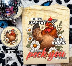 there is a t - shirt with a chicken on it next to some disco balls