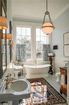 a bathroom with a tub, sink and rug