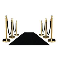 a black carpet with gold poles and ropes on the end is shown in front of a white background